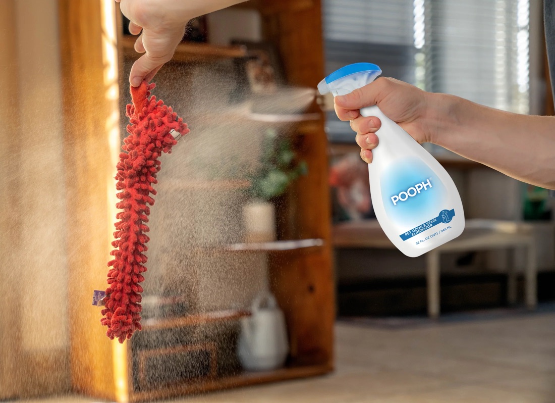 Pooph odor eliminator sprayed on a red dog toy