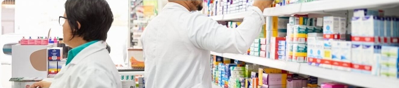 Pharmacists stocking OTC products on pharmacy shelves