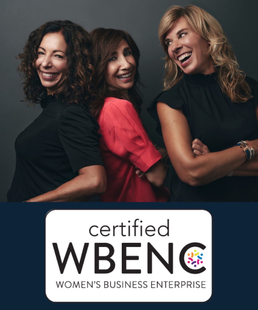 Owners Nancy, Tricia, and Sofia posing with the certified WBENC Women's Business Enterprise logo