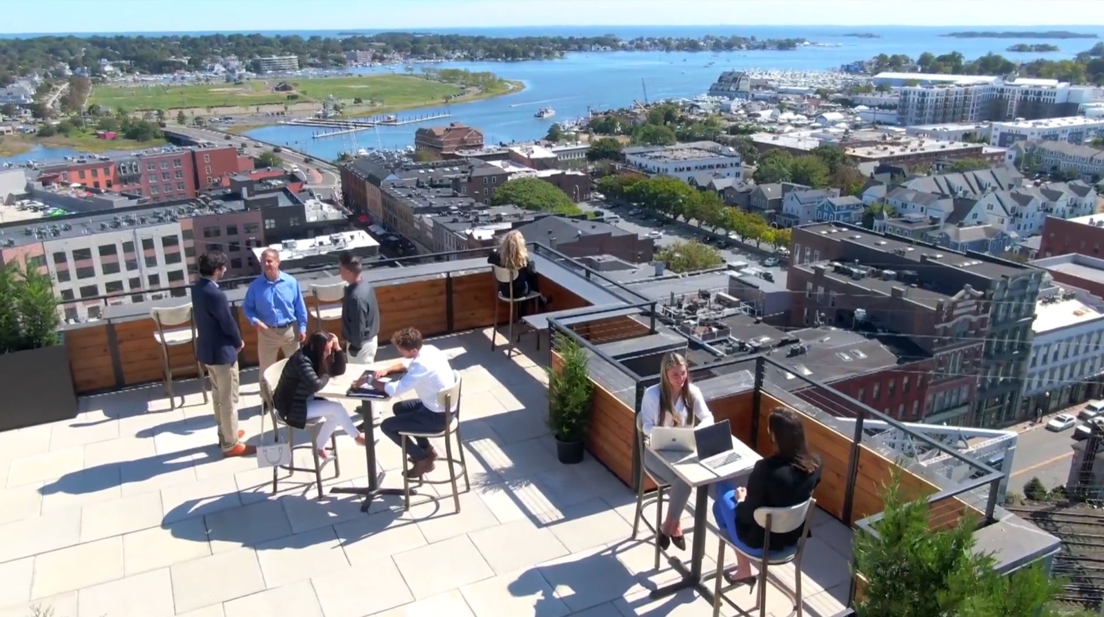 The team working and meeting on the SoNo 50 rooftop deck overlooking Norwalk harbor