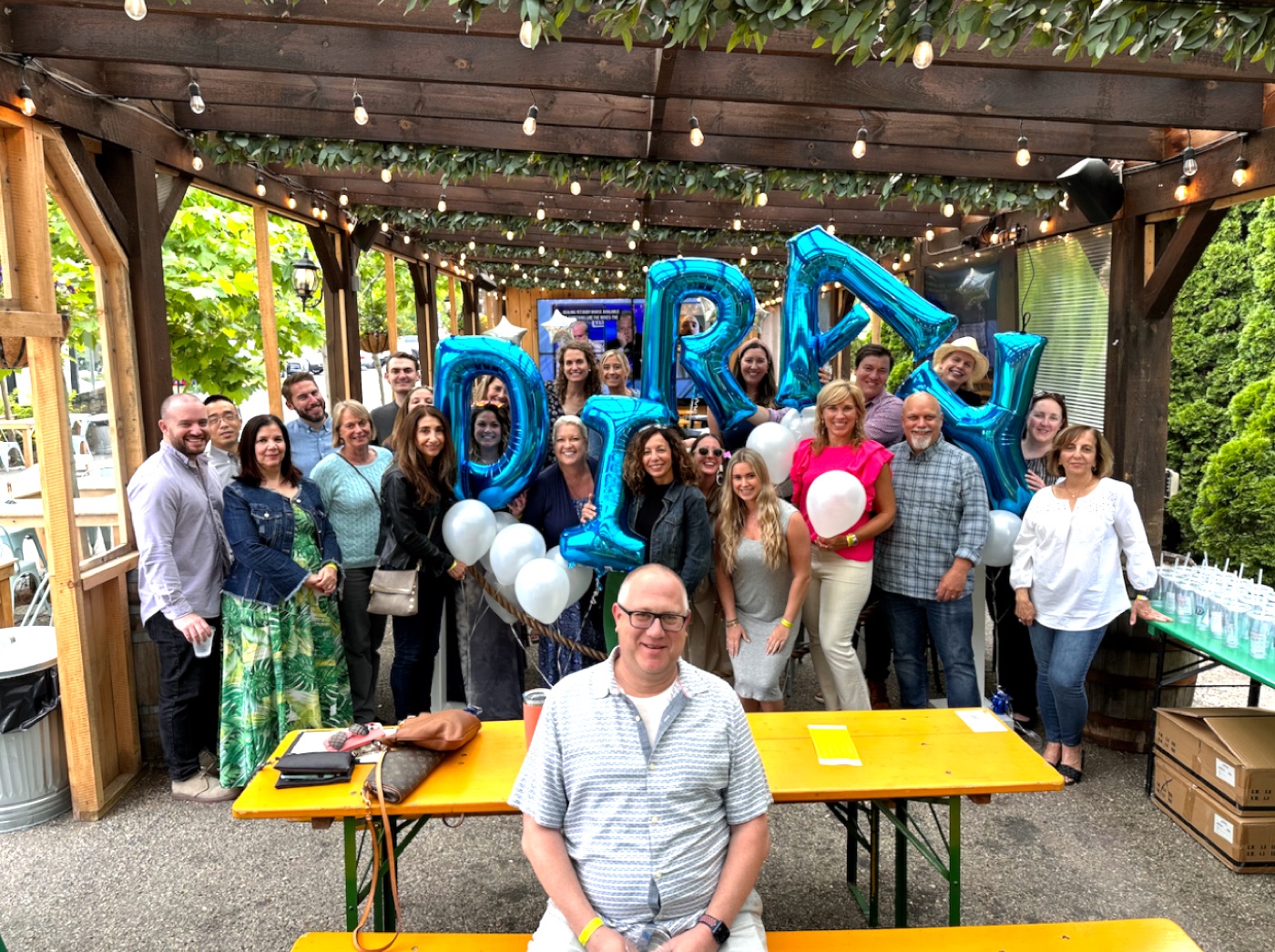 The team celebrating under Diray balloons